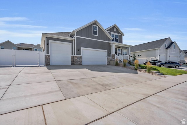 2873 S Puddle Ln, Saratoga Springs, UT 84045 - craftsman house with board and batten siding, stone siding, concrete driveway, and a porch