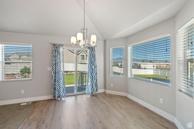 916 Cold Creek Way, Layton, UT 84041 - empty room featuring a chandelier, wood finished floors, and vaulted ceiling