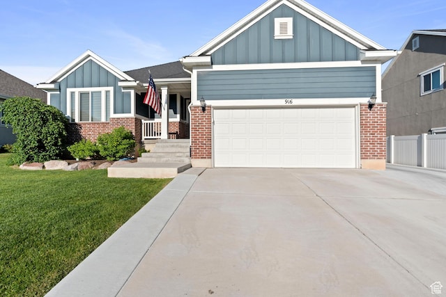 916 Cold Creek Way, Layton, UT 84041 - view of front of property featuring board and batten siding, driveway, brick siding, a garage, and a front yard