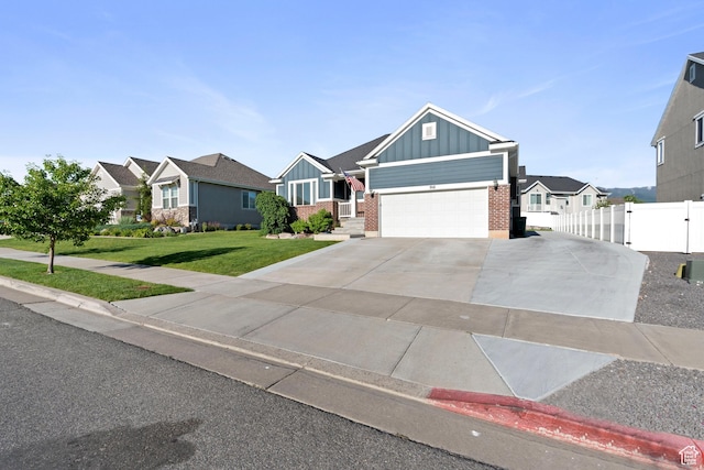 916 Cold Creek Way, Layton, UT 84041 - view of front of house with board and batten siding, brick siding, a residential view, driveway, and an attached garage