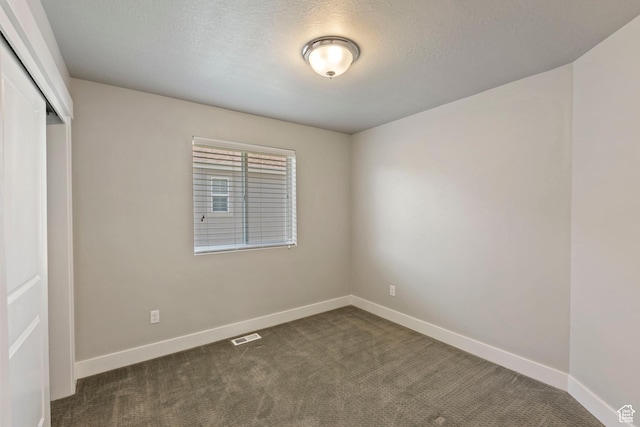 916 Cold Creek Way, Layton, UT 84041 - unfurnished bedroom featuring a closet, dark colored carpet, and a textured ceiling