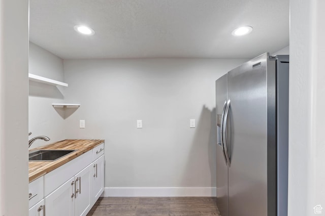 916 Cold Creek Way, Layton, UT 84041 - kitchen with stainless steel refrigerator with ice dispenser, open shelves, butcher block countertops, white cabinets, and wood finished floors