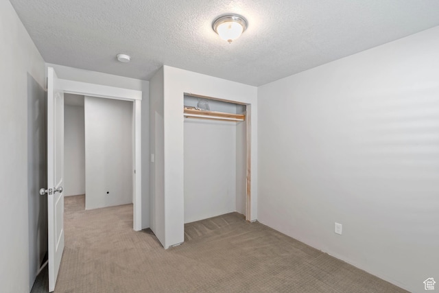 916 Cold Creek Way, Layton, UT 84041 - unfurnished bedroom featuring light colored carpet, a closet, and a textured ceiling