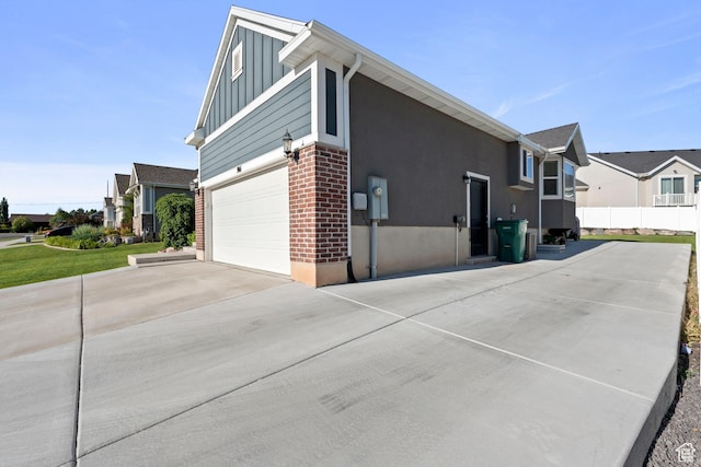 916 Cold Creek Way, Layton, UT 84041 - view of side of property featuring board and batten siding, concrete driveway, an attached garage, and a residential view