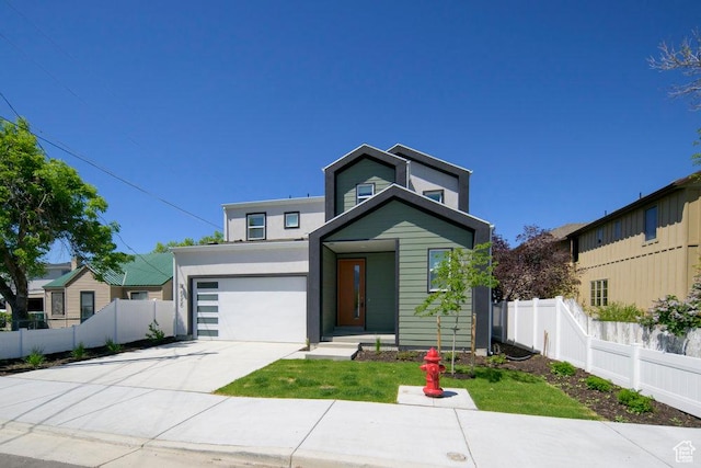 6556 S Jefferson St Unit 15, Murray, UT 84107 - contemporary home featuring concrete driveway, an attached garage, and stucco siding