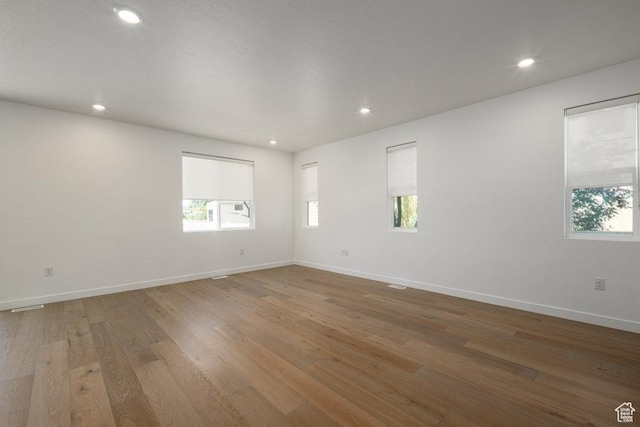 6556 S Jefferson St Unit 15, Murray, UT 84107 - spare room with healthy amount of natural light, recessed lighting, and wood finished floors
