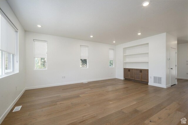 6556 S Jefferson St Unit 15, Murray, UT 84107 - unfurnished living room featuring built in features, light wood-type flooring, and recessed lighting