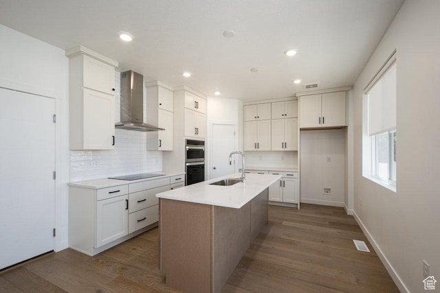 6556 S Jefferson St Unit 15, Murray, UT 84107 - kitchen with wall chimney exhaust hood, black electric stovetop, decorative backsplash, stainless steel double oven, and white cabinetry