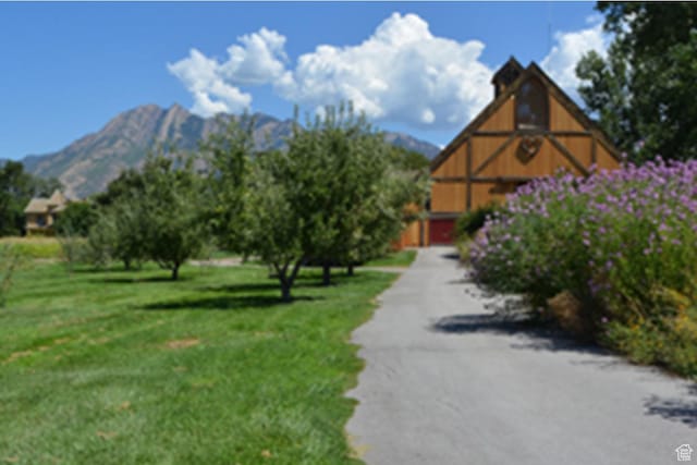 6556 S Jefferson St Unit 15, Murray, UT 84107 - view of community with a lawn, a mountain view, a barn, and driveway