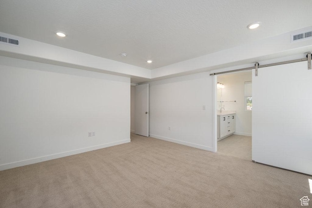 6556 S Jefferson St Unit 15, Murray, UT 84107 - unfurnished room with a barn door, light colored carpet, and recessed lighting