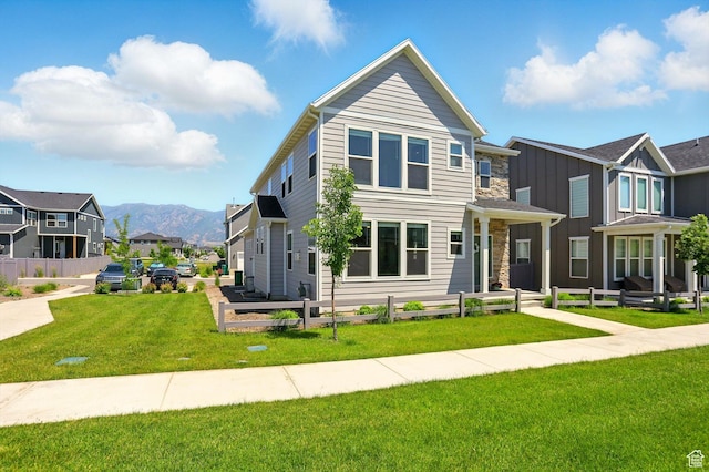847 N 2125 W, Layton, UT 84041 - view of front facade featuring a residential view, a front yard, a mountain view, and stone siding