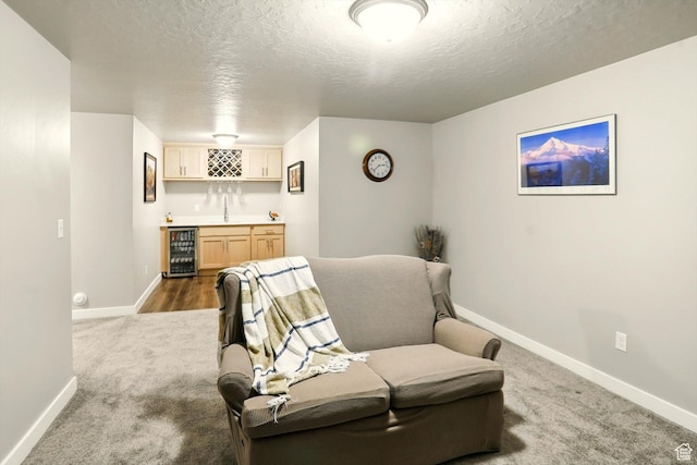 847 N 2125 W, Layton, UT 84041 - living area with beverage cooler, bar with sink, carpet flooring, and a textured ceiling