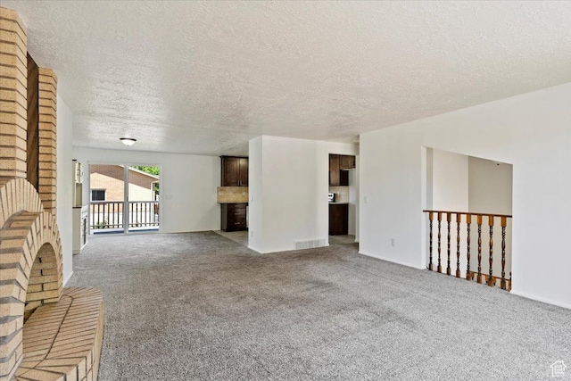 1128 W 4650 S, Riverdale, UT 84405 - unfurnished living room with carpet flooring and a textured ceiling