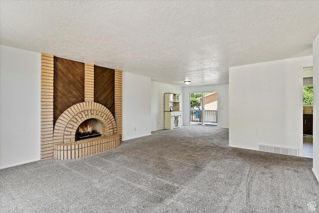 1128 W 4650 S, Riverdale, UT 84405 - unfurnished living room featuring a brick fireplace, carpet floors, and a textured ceiling