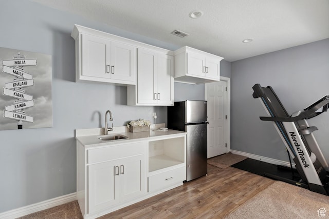 163 Cold Creek Way, Layton, UT 84041 - kitchen with freestanding refrigerator, white cabinets, light wood-style flooring, light countertops, and recessed lighting