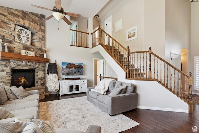 163 Cold Creek Way, Layton, UT 84041 - living area with a high ceiling, ceiling fan, dark wood-type flooring, stairway, and a stone fireplace