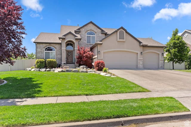 163 Cold Creek Way, Layton, UT 84041 - view of front of home featuring stone siding, stucco siding, a garage, and concrete driveway