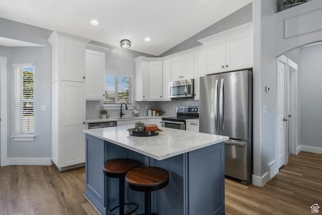 450 N 200 E, Lehi, UT 84043 - kitchen featuring appliances with stainless steel finishes, white cabinetry, a center island, dark wood finished floors, and lofted ceiling