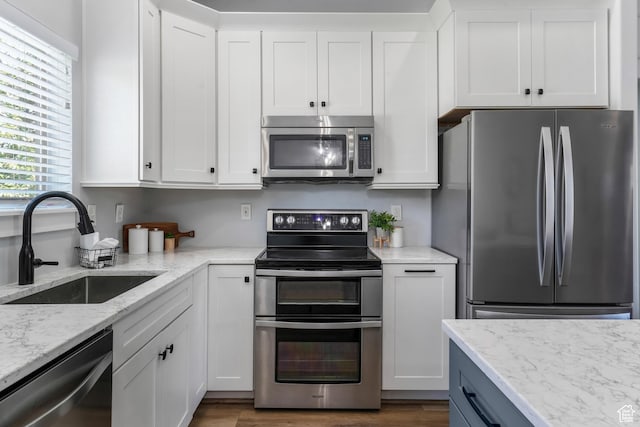 450 N 200 E, Lehi, UT 84043 - kitchen featuring appliances with stainless steel finishes, white cabinets, light stone countertops, and dark wood-style flooring