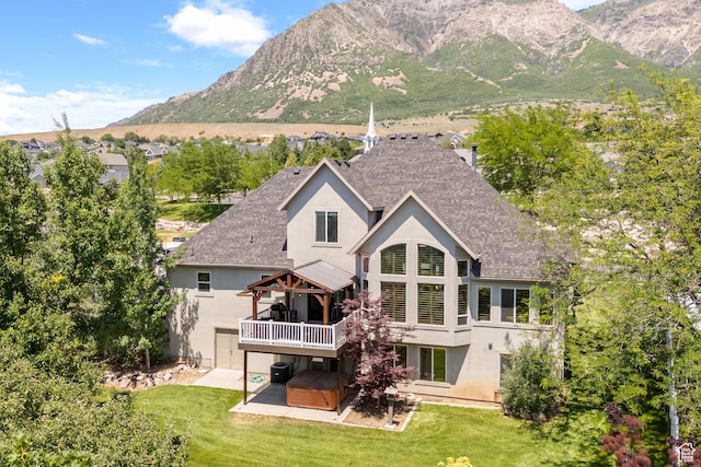 665 E 3550 N, North Ogden, UT 84414 - rear view of property with stucco siding, a shingled roof, a patio area, and a deck with mountain view