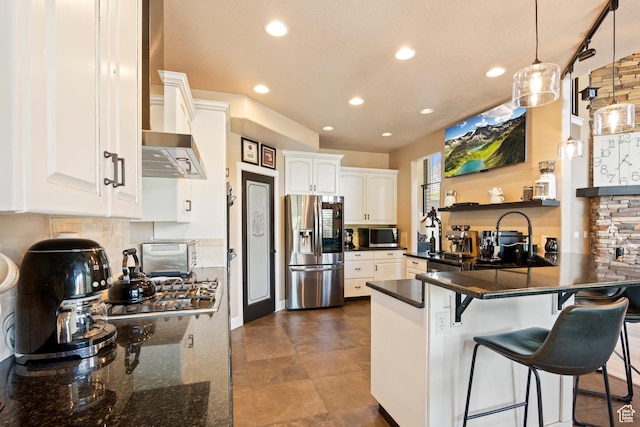 665 E 3550 N, North Ogden, UT 84414 - kitchen featuring stainless steel appliances, a peninsula, recessed lighting, white cabinetry, and wall chimney exhaust hood