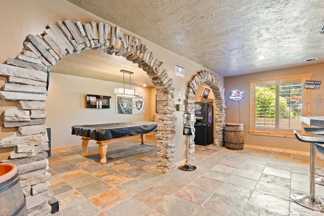 665 E 3550 N, North Ogden, UT 84414 - recreation room featuring billiards table, arched walkways, stone tile floors, and a textured ceiling