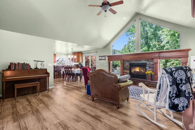 1644 W 1200 N, Farr West, UT 84404 - living area with ceiling fan, wood finished floors, plenty of natural light, a fireplace, and high vaulted ceiling