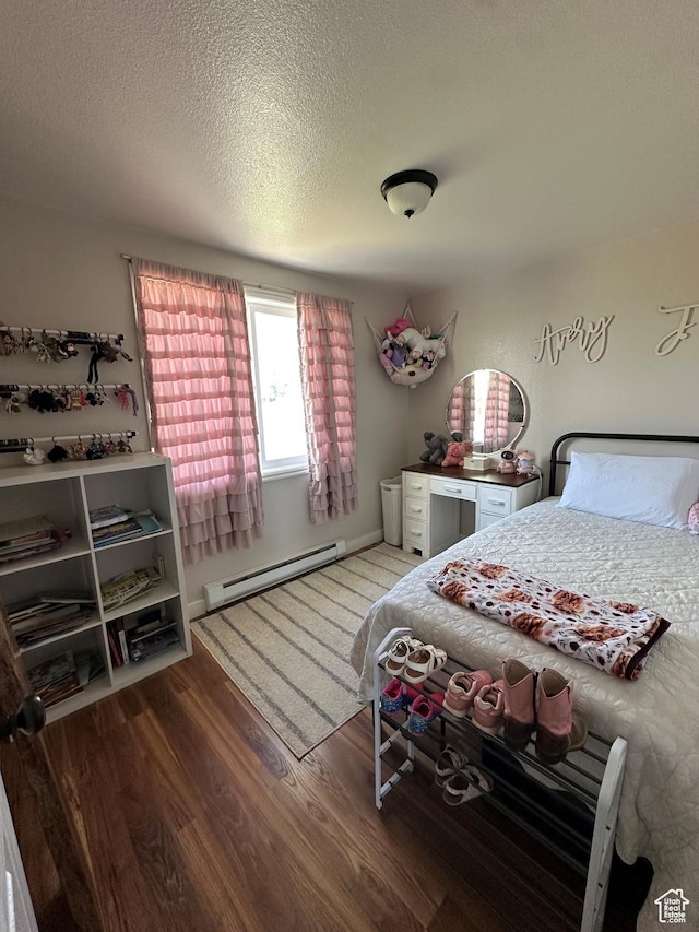 2714 E 1000 N, Ballard, UT 84066 - bedroom featuring a baseboard radiator, wood finished floors, and a textured ceiling