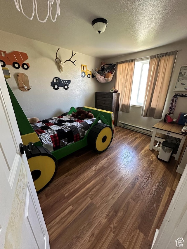 2714 E 1000 N, Ballard, UT 84066 - bedroom with a baseboard heating unit, wood finished floors, and a textured ceiling