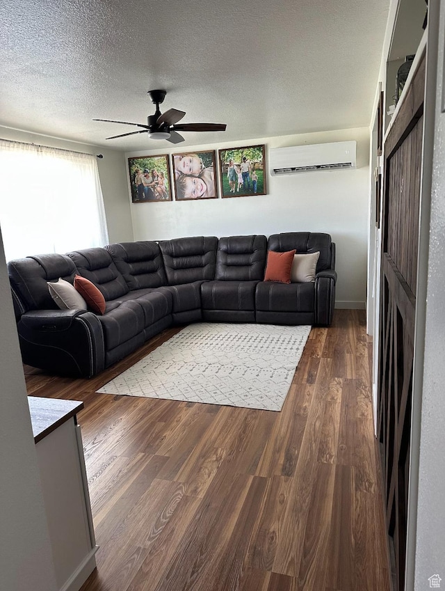 2714 E 1000 N, Ballard, UT 84066 - living room featuring a wall mounted AC, a ceiling fan, wood finished floors, and a textured ceiling