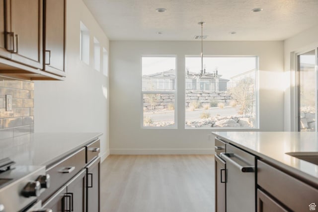 32 Rosalia Rdg, St George, UT 84770 - kitchen with light wood finished floors, light countertops, electric range, stainless steel dishwasher, and a chandelier