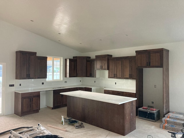 908 N 140 W, Mayfield, UT 84643 - kitchen featuring lofted ceiling, backsplash, a center island, dark brown cabinetry, and light carpet