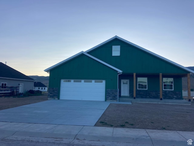 908 N 140 W, Mayfield, UT 84643 - ranch-style house with an attached garage, a porch, driveway, and stone siding