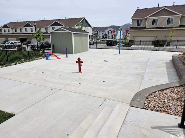 940 N Center St, Santaquin, UT 84655 - view of community featuring a residential view, an attached garage, concrete driveway, and a shed