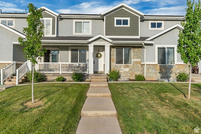 940 N Center St, Santaquin, UT 84655 - view of front of house featuring stone siding, a porch, stucco siding, and a front lawn