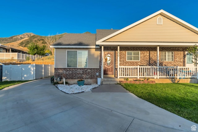 382 N Peach St, Santaquin, UT 84655 - view of front of home with brick siding, a porch, and a mountain view