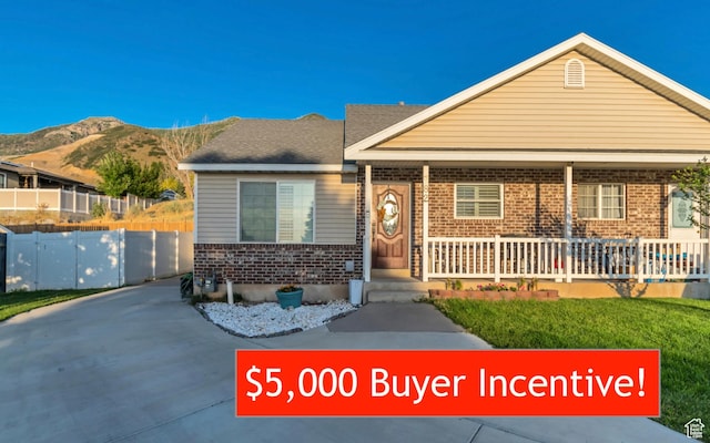 382 N Peach St, Santaquin, UT 84655 - view of front of house with a porch, brick siding, and a mountain view