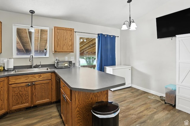 416 N 450 W, Clearfield, UT 84015 - kitchen featuring fridge, a peninsula, dark wood-style floors, and brown cabinetry