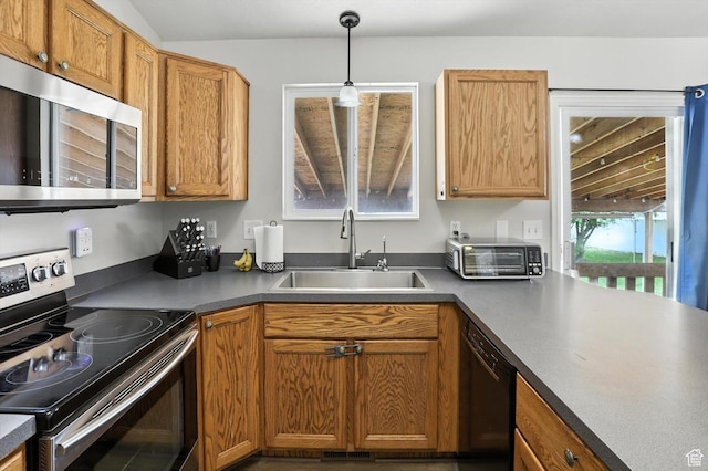 416 N 450 W, Clearfield, UT 84015 - kitchen featuring stainless steel appliances, decorative light fixtures, dark countertops, and brown cabinetry