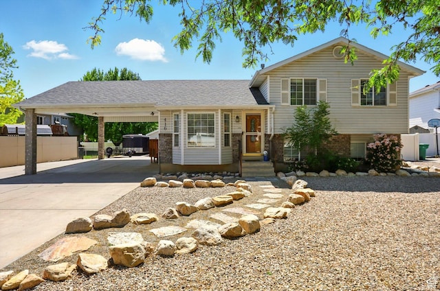 416 N 450 W, Clearfield, UT 84015 - tri-level home with concrete driveway, a carport, brick siding, and entry steps