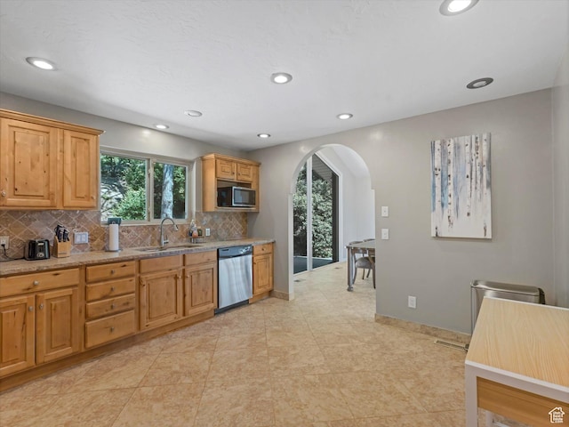 4783 S Bron Breck St, Salt Lake City, UT 84117 - kitchen featuring dishwasher, arched walkways, decorative backsplash, healthy amount of natural light, and recessed lighting