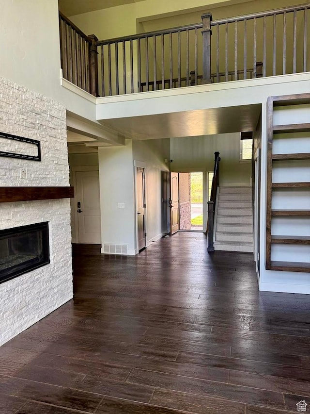 475 W 1150 N Unit 5, Midway, UT 84049 - unfurnished living room featuring a high ceiling, stairway, a fireplace, and wood-type flooring