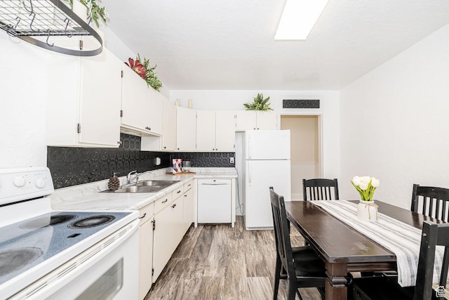 13 N 100 W, Smithfield, UT 84335 - kitchen featuring white appliances, light countertops, white cabinets, light wood finished floors, and decorative backsplash