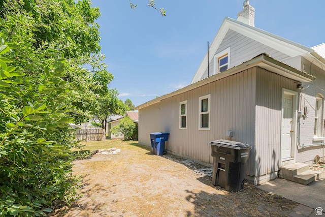 13 N 100 W, Smithfield, UT 84335 - view of side of home with entry steps, a chimney, and a metal roof