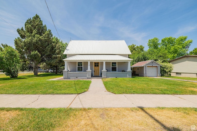13 N 100 W, Smithfield, UT 84335 - view of front facade with covered porch, a detached garage, a front lawn, a metal roof, and driveway