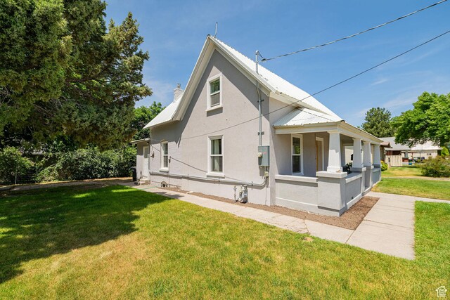 13 N 100 W, Smithfield, UT 84335 - back of property with stucco siding, a yard, and a metal roof
