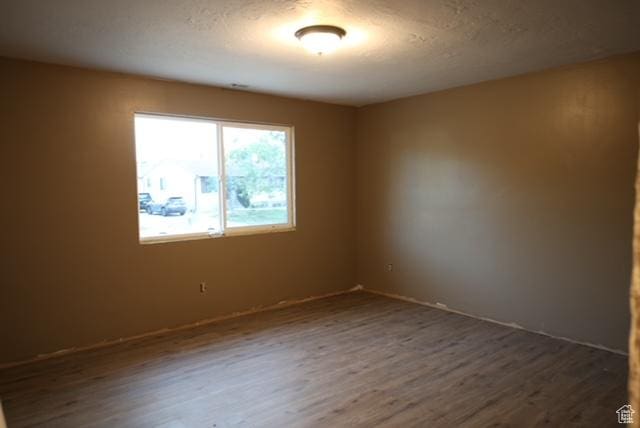 591 E Acoma Rd A-B, Unit A-B Midvale, UT 84047 - empty room featuring dark wood-style flooring and baseboards