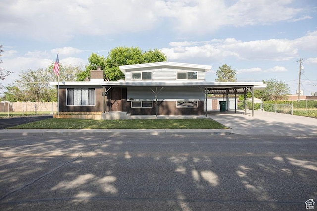 19 S Dale Ave, Vernal, UT 84078 - view of front of home featuring driveway, brick siding, a carport, and a chimney