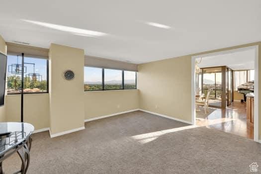 426 S 1000 E Unit 707, Salt Lake City, UT 84102 - unfurnished living room featuring baseboards and carpet flooring