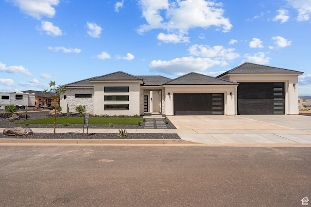1762 S 920 W, Hurricane, UT 84737 - view of front of house with a garage, stucco siding, driveway, and a tiled roof
